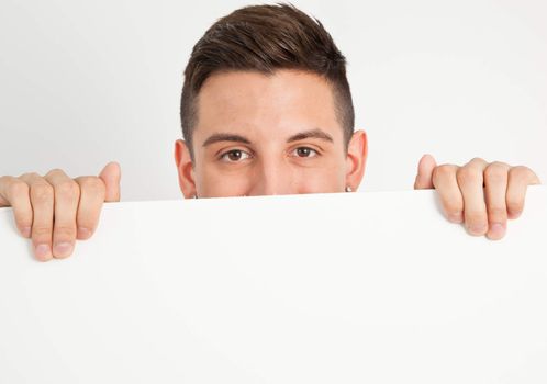 Young and handsome guy posing over white background