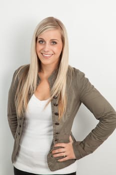 Young blond woman smiling against a white background