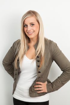 Young blond woman smiling against a white background