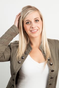 Young blond woman smiling against a white background