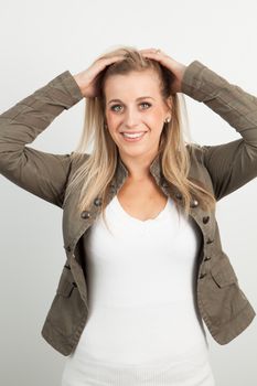 Young blond woman smiling against a white background