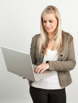 Young blond woman smiling against a white background