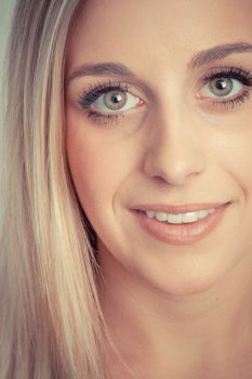 Young blond woman smiling close up