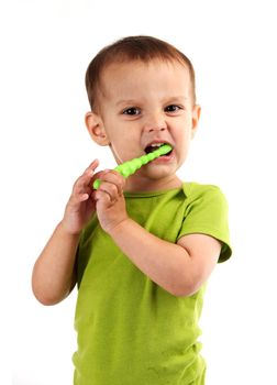 Cute little boy brushing teeth, isolated on white background