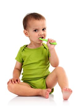 Cute little boy brushing teeth, isolated on white background