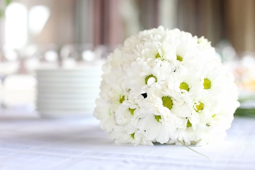 Decoration of the dining table for wedding reception, bouquet of daisies