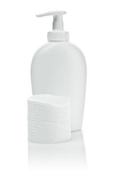 white bottle and cotton pads