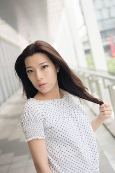 Attractive young woman, closeup glamour portrait at street in modern city, Taipei, Taiwan, Asia.