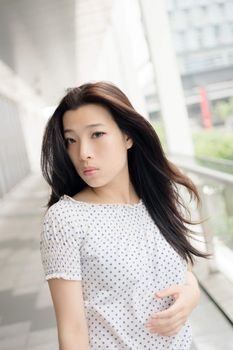 Attractive young woman, closeup glamour portrait at street in modern city, Taipei, Taiwan, Asia.