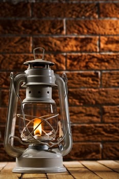 kerosene lamp on brick background