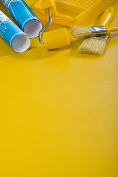 paint tools on yellow background with copyspace