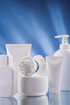 set of white skincare accessories o0n blue background