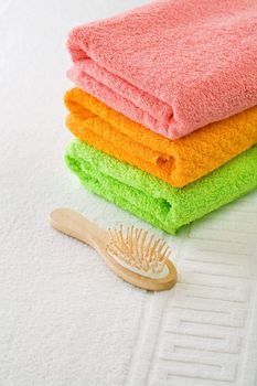 three cotton towels with hairbrush