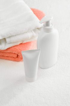 tube and spray bottle with towels
