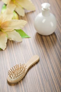 round bottle and hairbrush with flower