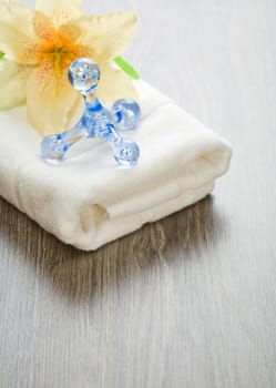 flower and massager on white towel