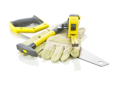tapeline, hammer and gloves on saw