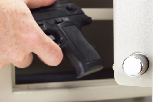 Person putting firearm in gun safe