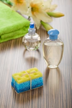 group of bath articles and flower on wooden background