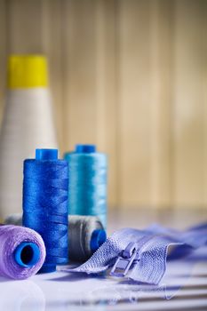 sewing spools and zip on table