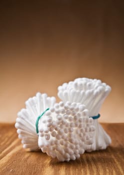 white cotton swabs on wooden background