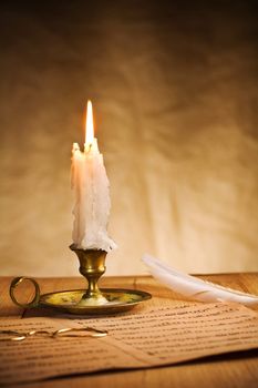burning candle and music sheet