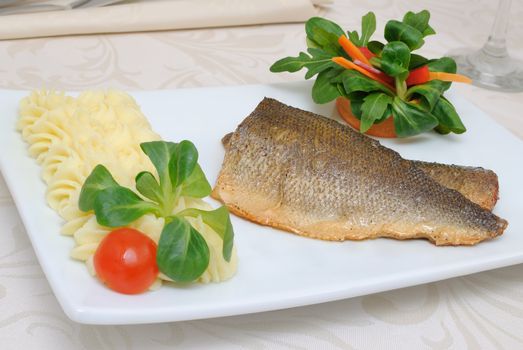 Baked fillet of sea bass with vegetables and mashed potato mix