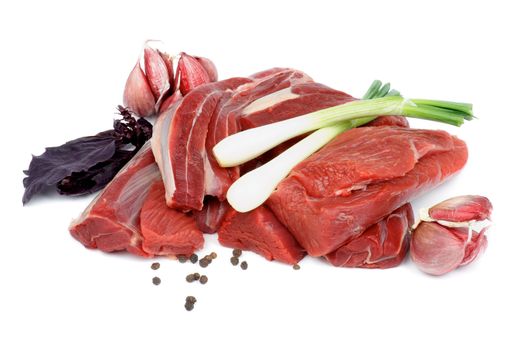 Boneless Raw Beef with Basil, Spring Onion, Garlic and Pepper Corn isolated on white background