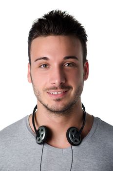 Handsome smiling young man with headphones around his neck, isolated on white