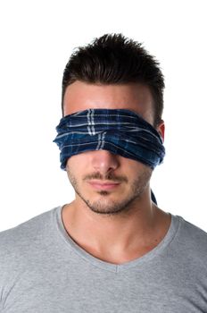 Handsome blindfolded young man with eyes covered. Concept of confusion, problem, challenge, losing your way