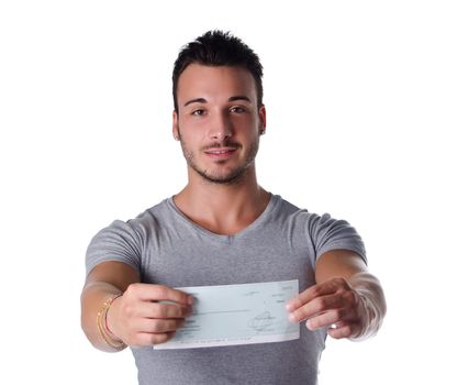 Young man showing check (cheque) in his hands, looking at camera