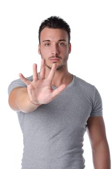 Attractive and athletic young man doing stop gesture with his hand, isolated on white