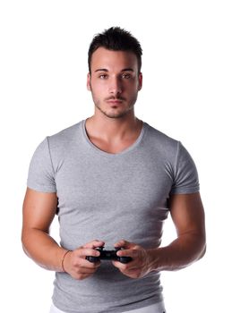 Attractive young man using joystick or joypad for videogames, isolated on white