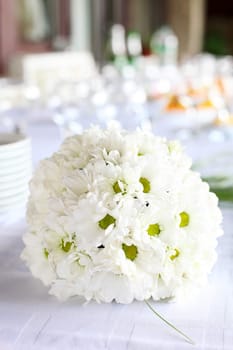 Decoration of the dining table for wedding reception, bouquet of daisies