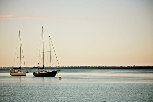 Two Sailing Boats Anchoured in Shallow Water