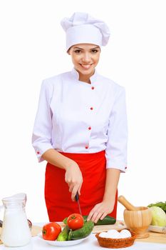 Young cook preparing food wearing a red apron