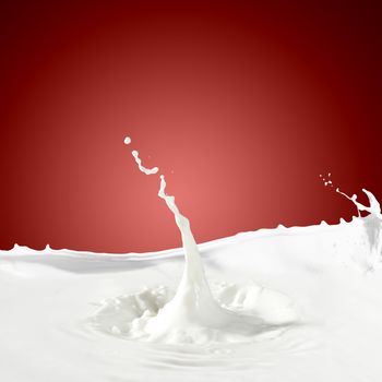 Pouring white milk splash on colour background