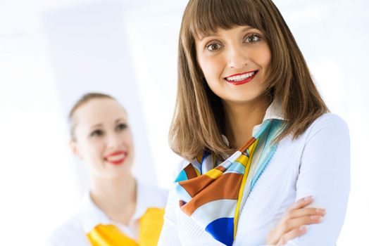 Portrait of a young successful business woman standing against colleagues