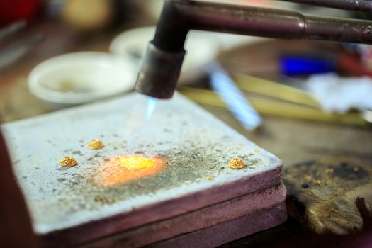 Goldsmith working with a thai traditional gold