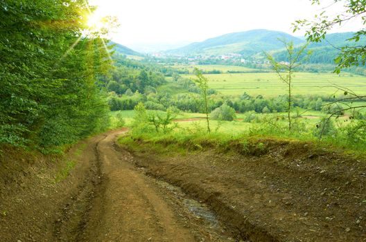 A dirt road in the mountains overlooking the village