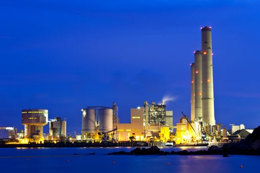 Smoking industrial power plant at night 