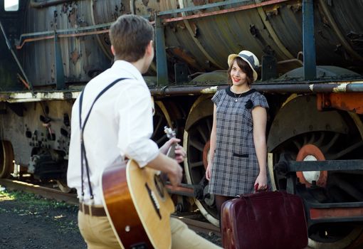 Retro hip hipster romantic love couple serenade  vintage train setting