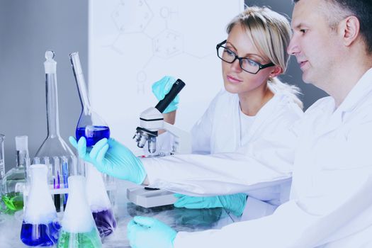  two scientist in chemical lab conducting experiments