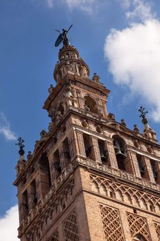 Giralda Spire, Bell Tower, Seville Cathedral, Cathedral of Saint Mary of the See, Seville, Andalusia Spain.  Built in the 1500s.  Largest Gothic Cathedral in the World and Third Largest Church in the World.  Burial Place of Christopher Columbus.  Giralda is a former minaret converted into a bell tower
