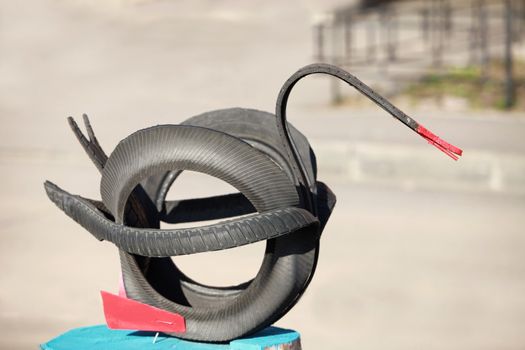 It is a sculpture of an old car tire black swan for garden design