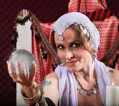 Gorgeous female fortune teller holding a crystal ball