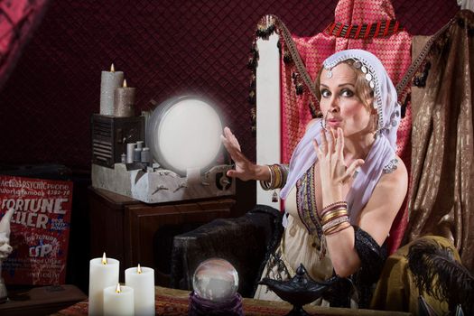 Beautiful fortune teller with hand over her mouth