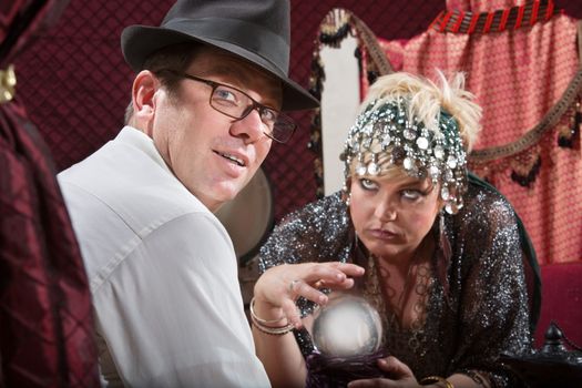 Businessman with eyeglasses with crystal ball fortune teller