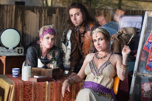 Three good looking fortune tellers outside with magic lamp