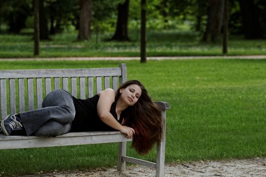 pretty young girl couch on a bench